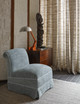 Upholstered chair in Kito Pale Blue, set against textured walls and Asama curtains. Hubert Zandburg install in showroom Photo by James McDonald.